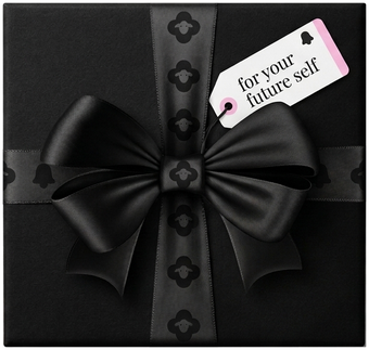 A black gift box tagged for your future self: a vision board inside